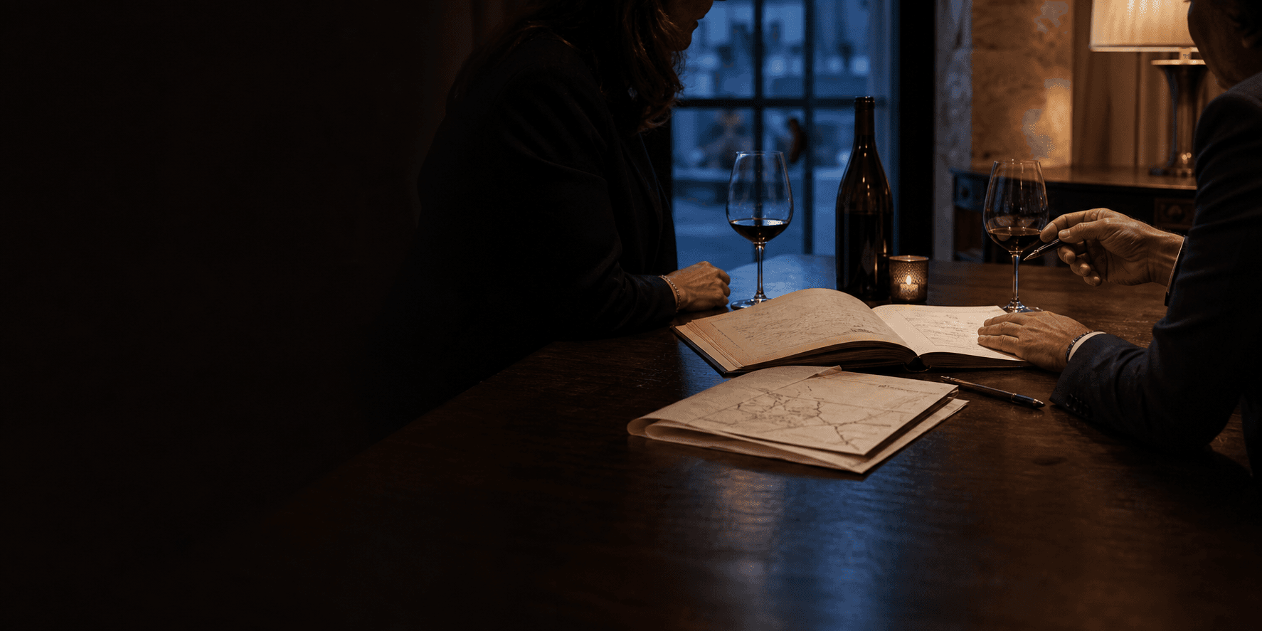 A private wine advisor and client reviewing a cellar report and journey plan